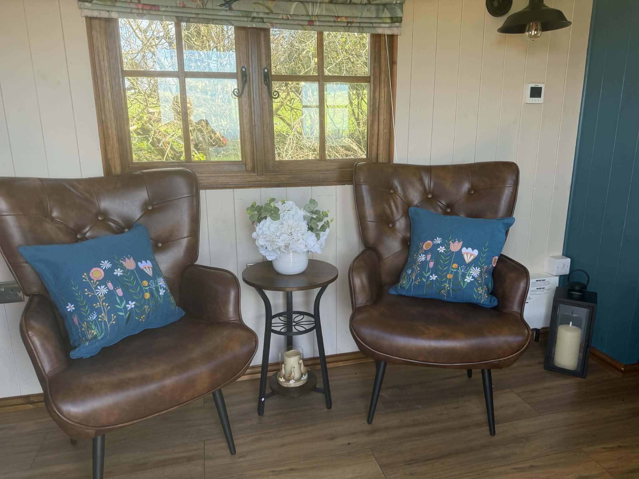 Private wooden deck of the hut at sunset with seating area